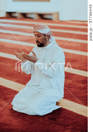 Muslim Arabic man praying. Religious muslim man praying inside the mosque during ramadan 97786449