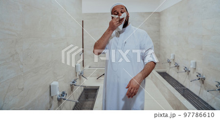 A portrait of a man in abdesthana using a towel 97786610