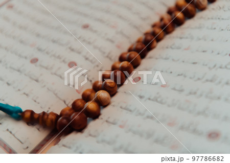 Photo of the holy Islamic book of the Qoran in a modern mosque Photo of the holy Islamic book of the Qoran in a modern mosque 97786682