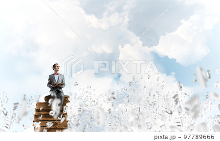 Young businessman or student studying the science and symbols fly around 97789666