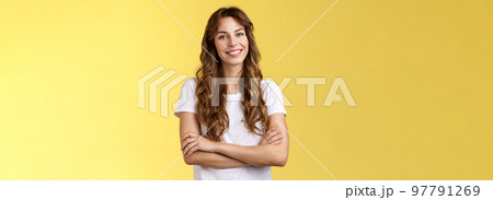 Confident carefree lively smiling female freelancer professional cross arms chest self-assured pose stand comfortable white t-shirt grinning toothy delighted stand yellow background friendly 97791269