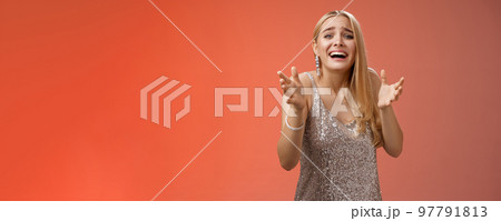 Panicking upset miserable heartbroken blond girl crying raising hands begging not go broke-up boyfriend look sorrow distressed freak-out standing devastated red background during party Panicking upset miserable heartbroken blond girl crying raising hands begging not go broke-up boyfriend look sorrow distressed freak-out standing devastated red background during party 97791813