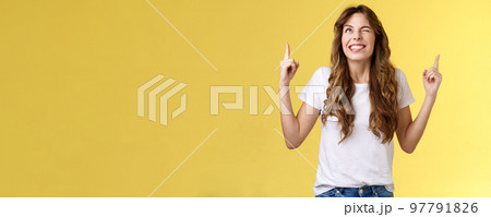 Cheeky confident positive attractive female optimistic joyful vibe smiling toothy wink grinning look up sassy pointing top making deal god hinting making cunning mood stand yellow background Cheeky confident positive attractive female optimistic joyful vibe smiling toothy wink grinning look up sassy pointing top making deal god hinting making cunning mood stand yellow background 97791826
