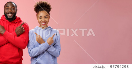 Charming happy couple african american boyfriend girlfriend move in together pointing different sides cross arms chest left right smiling broadly upbeat have variety good choices opportunities 97794298