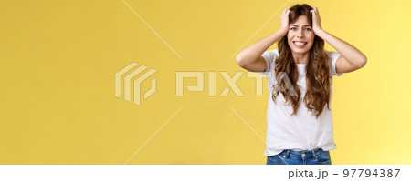 Girl panicking huge trouble suffer panic-attack grimacing painful feelings inside hold hands head troubled frustrated frowning anxiously staring camera troublesome problematic situation 97794387