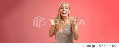 Panicking upset miserable heartbroken blond girl crying raising hands begging not go broke-up boyfriend look sorrow distressed freak-out standing devastated red background during party Panicking upset miserable heartbroken blond girl crying raising hands begging not go broke-up boyfriend look sorrow distressed freak-out standing devastated red background during party 97794485
