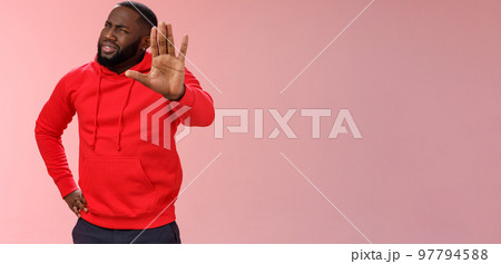 Hold on, stop right there. Portrait confused perplexed african american man cringing questioned raise hand enough shut up gesture arguing hear stupid nonsense, standing pink background 97794588