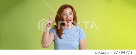 Got excellent idea solution up there. Excited smart creative middle-aged mature woman ginger hair raise index finger eureka pointing top explain offer terms smiling describe cool advertisement 97794773