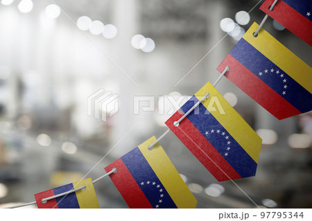 A garland of Venezuela national flags on an abstract blurred background 97795344