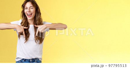 Hey visit my link would not regret. Lively cheeky enthusiastic woman curly long haircut wink sassy smiling broadly show you perfect copy space pointing down bottom promo yellow background Hey visit my link would not regret. Lively cheeky enthusiastic woman curly long haircut wink sassy smiling broadly show you perfect copy space pointing down bottom promo yellow background 97795513