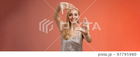 Charming creative young elegant blond female photographer blogger search inspiration picking right angle take cool shot making frames hands smiling broadly look through, red background Charming creative young elegant blond female photographer blogger search inspiration picking right angle take cool shot making frames hands smiling broadly look through, red background 97795980