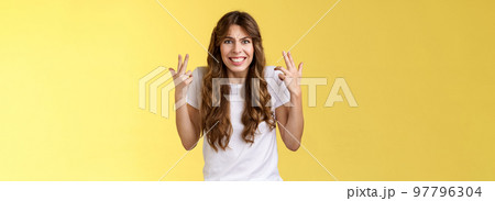 Pissed fed up angry freaked-out woman gesturing intense shaking hands furiously being outraged clench teeth frowning grimacing disappointed complain swearing cursing rude yellow background 97796304
