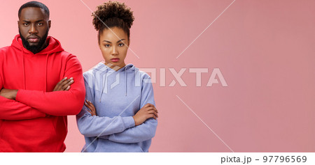 Two attractive african friends coworkers serious-looking standing confident strong pose arms crossed chest look determined focused camera wanna beat rival team computer game, self-assured Two attractive african friends coworkers serious-looking standing confident strong pose arms crossed chest look determined focused camera wanna beat rival team computer game, self-assured 97796569