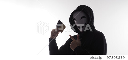 Hacker man and credit cards in hand. Represent credit cards personal data stolen by anonymous man in Black hood shirt. Credit cards data security and Cyber crime digital. Money transection unsecured. 97803839