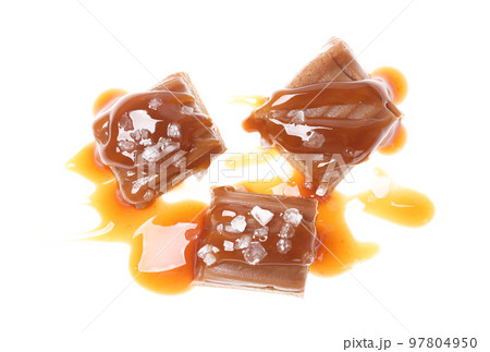 Delicious salted caramel with sauce on white background, top view 97804950