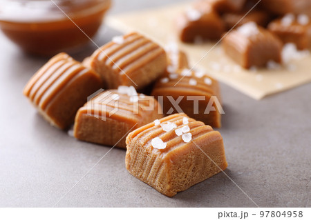 Salted caramel on light grey table, closeup 97804958