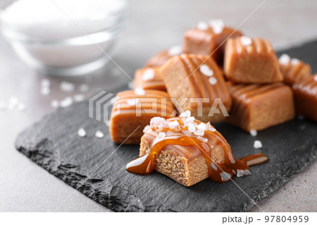Salted caramel on slate board, closeup view 97804959