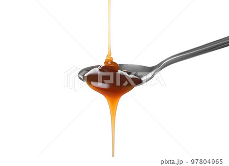 Pouring salted caramel into spoon isolated on white 97804965