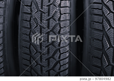 Black car tires as background, closeup. Auto store 97804982