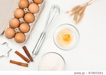 Flat lay composition with raw eggs and other ingredients on white table. Baking pie 97805091