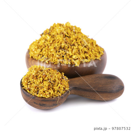 Osmanthus tea in wooden bowl and spoon, isolated on white background. Dry flowers of Osmanthus fragrans. 97807532