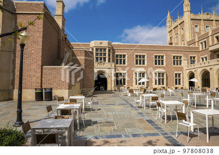 Los Angeles, USA. September 20, 2022. Chairs and tables arranged in front of facade of UCLA building with blue sky in the background during sunny day Los Angeles, USA. September 20, 2022. Chairs and tables arranged in front of facade of UCLA building with blue sky in the background during sunny day 97808038