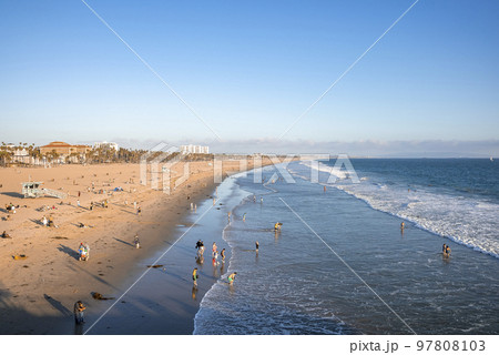Los Angeles, USA. September 20, 2022. Aerial view of people enjoying at Venice beach and scenic view of waves splashing on shore with clear blue sky in background during sunset Los Angeles, USA. September 20, 2022. Aerial view of people enjoying at Venice beach and scenic view of waves splashing on shore with clear blue sky in background during sunset 97808103