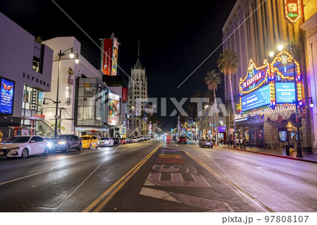Los Angeles, USA. September 20, 2022. Text and road markings on street amidst illuminated El Capitan theatre and buildings in a row at Hollywood Boulevard in city during nighttime Los Angeles, USA. September 20, 2022. Text and road markings on street amidst illuminated El Capitan theatre and buildings in a row at Hollywood Boulevard in city during nighttime 97808107