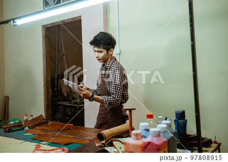 asian craftsman looking leather craft patterns on the screen pad asian craftsman looking leather craft patterns on the screen pad 97808915