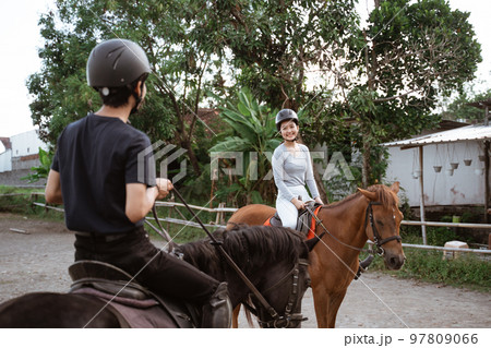 equestrian female athlete meeting her friend during training 97809066