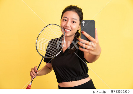 front view of woman holding selfie racket using phone camera front view of woman holding selfie racket using phone camera 97809109