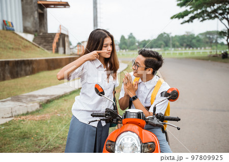 A student girl points finger at a male student 97809925