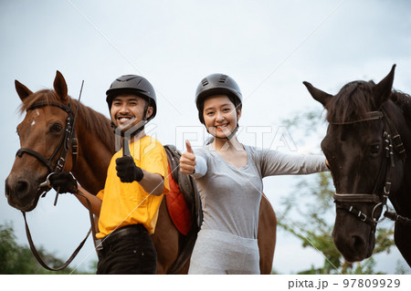 two equestrian athletes ride horses and start training 97809929