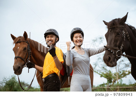 two equestrian athletes ride horses and start training 97809943