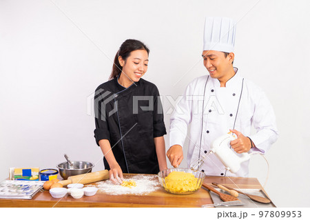 male and female chefs making cookie dough and using mixer male and female chefs making cookie dough and using mixer 97809953