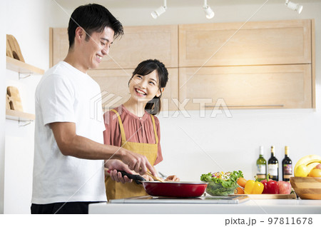 料理をする若い夫婦 97811678