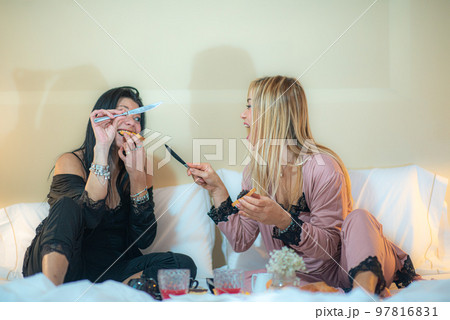 adorable diverse lgbt female couple in bodysuit lying in bed on cream sheets chating after sleeping adorable diverse lgbt female couple in bodysuit lying in bed on cream sheets chating after sleeping 97816831