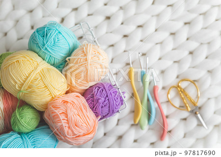Cozy homely atmosphere. Female hobby knitting. Yarn pastel multicolor in a basket. Cozy homely atmosphere. Female hobby knitting. Yarn pastel multicolor in a basket. 97817690