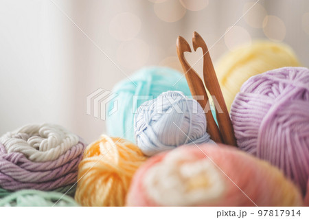 Cozy homely atmosphere. Female hobby knitting. Yarn pastel multicolor in a basket.  Cozy homely atmosphere. Female hobby knitting. Yarn pastel multicolor in a basket.  97817914