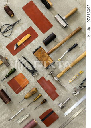 Top view materials and instruments on cutting mat for chopping measurement leatherwork details 97818095