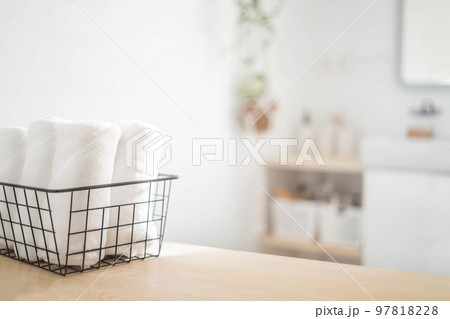 Spa white towel rolled in metallic basket comfortable hygiene fresh textile bathroom. Blurred background Spa white towel rolled in metallic basket comfortable hygiene fresh textile bathroom. Blurred background 97818228