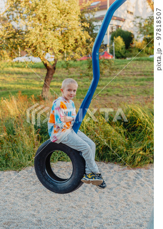 Funny cute happy baby playing on the playground. The emotion of happiness, fun, joy. Smile of a child. boy playing on the playground 97818507