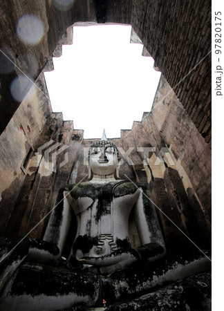 Giant buddha image in Si Chum temple, Sukhothai Historical Park Giant buddha image in Si Chum temple, Sukhothai Historical Park 97820175