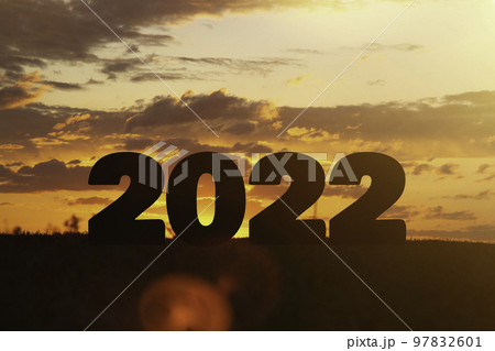 Year change. The beginning of a new year. New year concept. Symbol of start and greetings happy new year 2022. People enter 2022. Year change. The beginning of a new year. New year concept. Symbol of start and greetings happy new year 2022. People enter 2022. 97832601