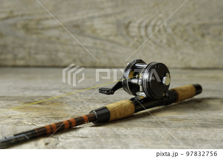 テーブルの上に置かれた釣り竿とリール 97832756
