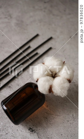 Transparent bottle of aroma diffuser. Parfum for home with cotton flowers 97836020