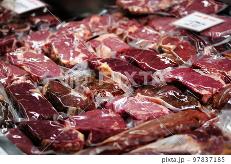 Beef, veal, lamb fresh raw steaks are packaged in vacuum and sold on market. 97837185
