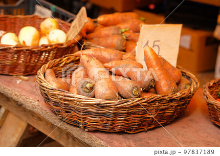 Carrots are sold at local vegetable farming market. Sale of fresh vegetables after harvesting. Carrots are sold at local vegetable farming market. Sale of fresh vegetables after harvesting. 97837189