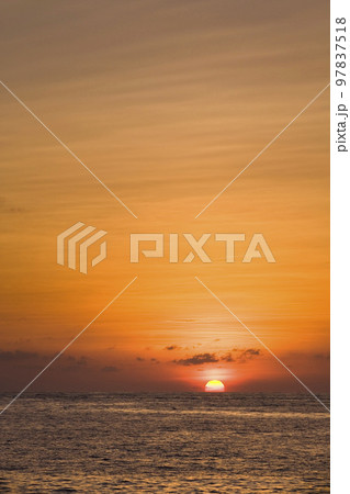 Colorful and beautiful sunset reflected into the ocean Colorful and beautiful sunset reflected into the ocean 97837518