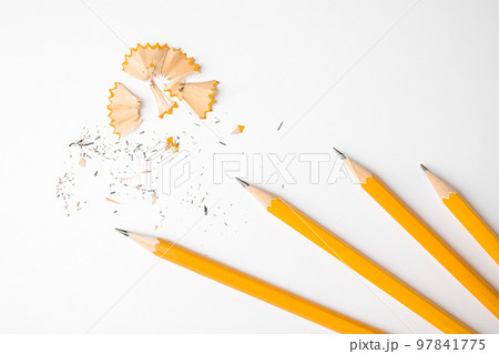 Graphite pencils and shavings on white background, top view Graphite pencils and shavings on white background, top view 97841775